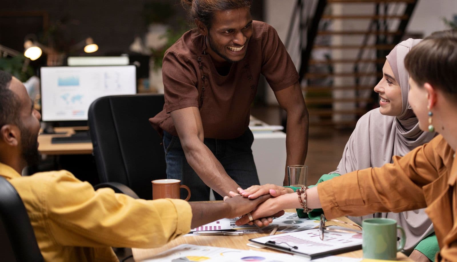 A sales team in conversation around a table